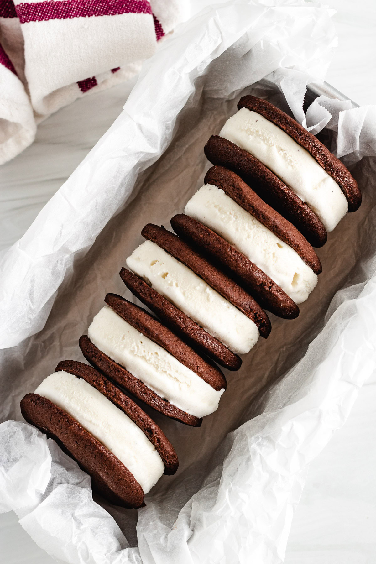 Homemade ice cream sandwiches lined up in a pan.