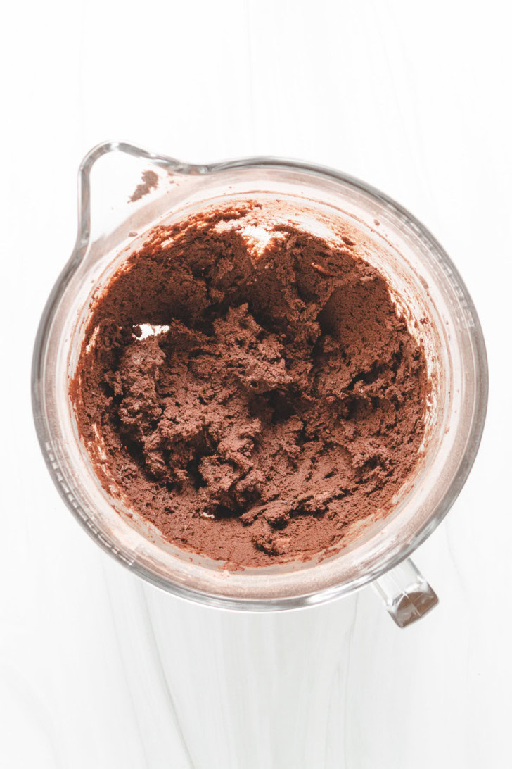 Mixed chocolate cookie dough in a glass bowl.