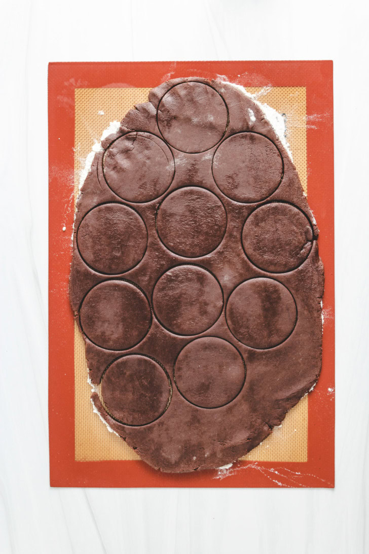 Rolled chocolate cookie dough cut into circles.