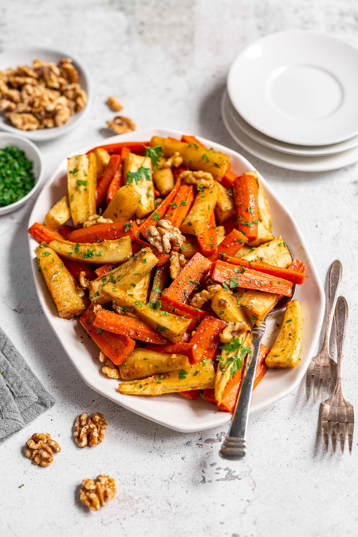 Close-up of roasted carrots and parsnips with walnuts.