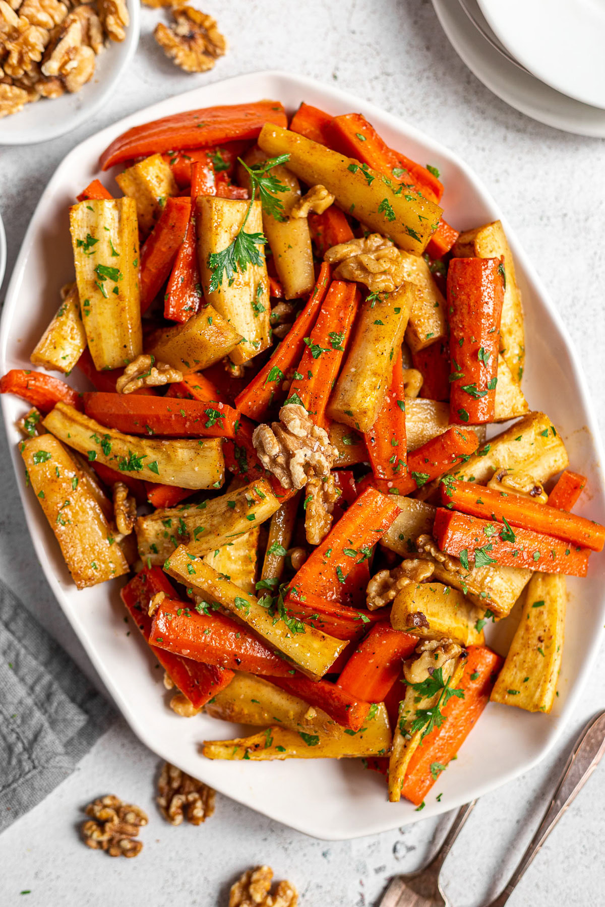 Platter of roasted carrots and parsnips with walnuts.