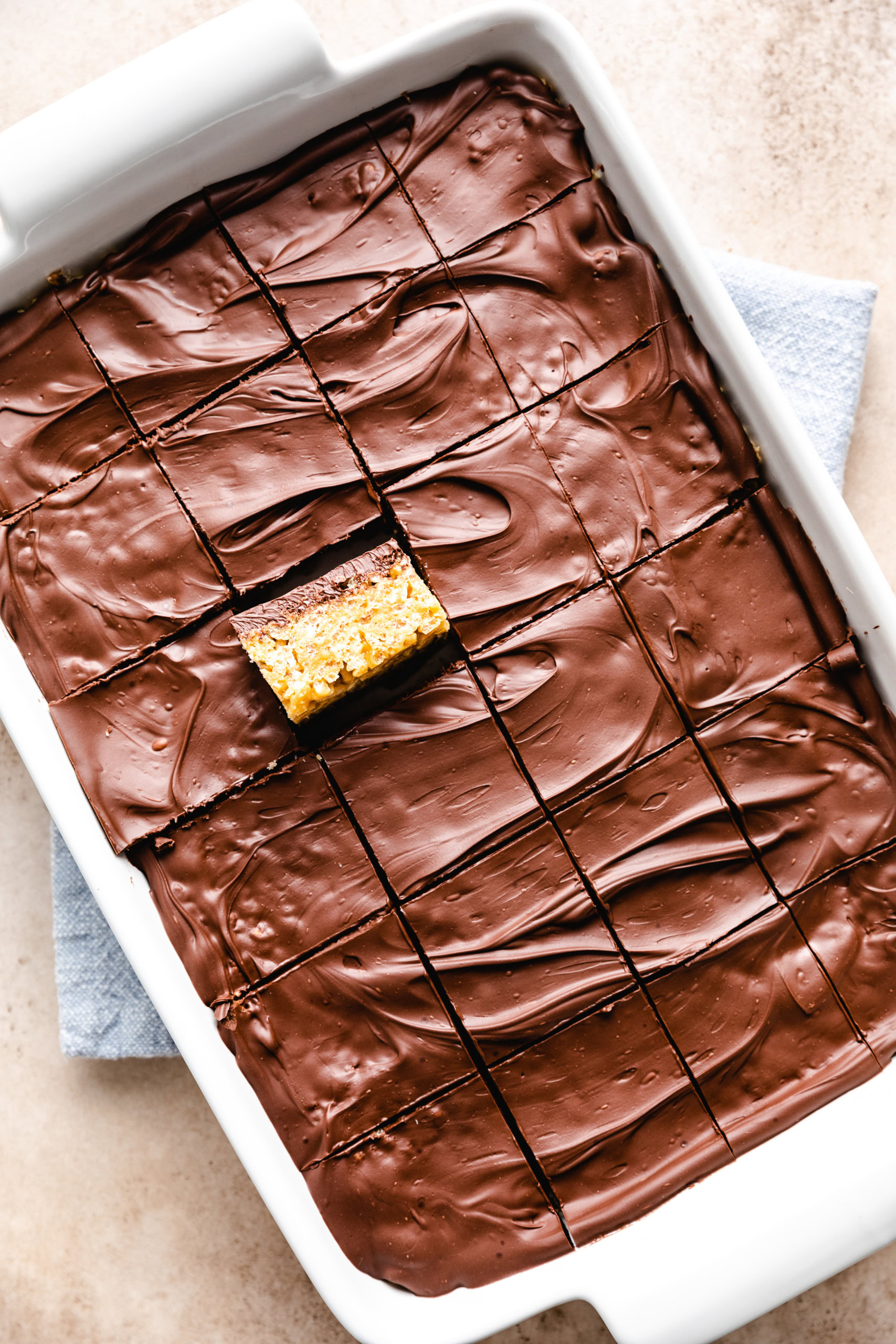 Chocolate-covered rice krispie treats cut into squares.