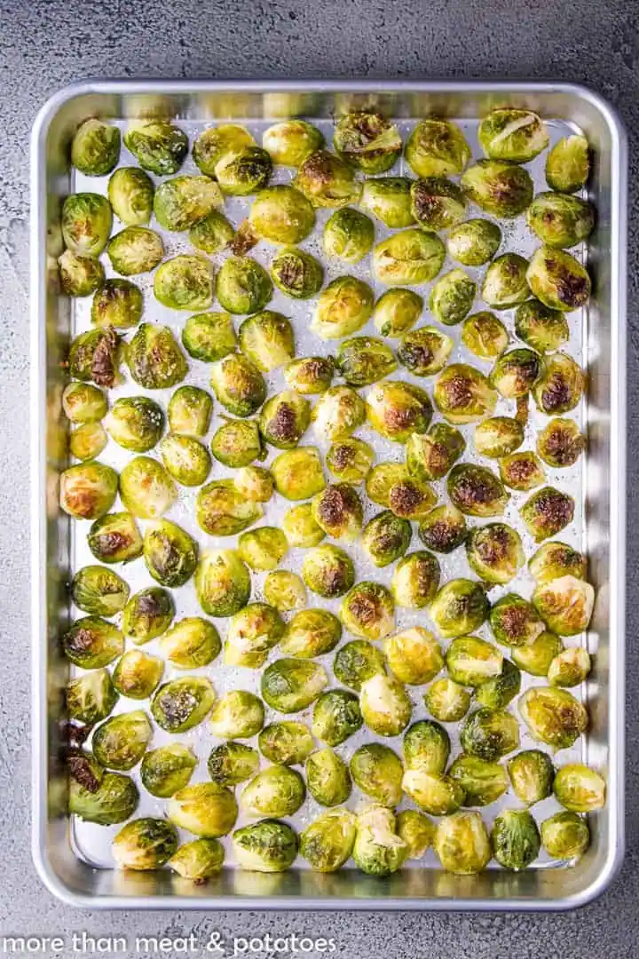 Roasted Brussels sprouts on a sheet pan.