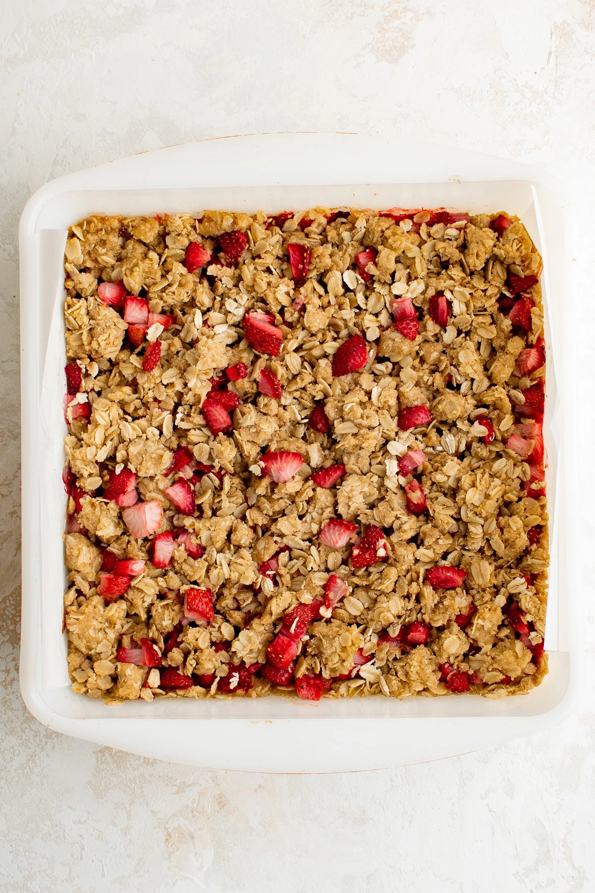 Baked strawberry oatmeal bars in a square baking dish.