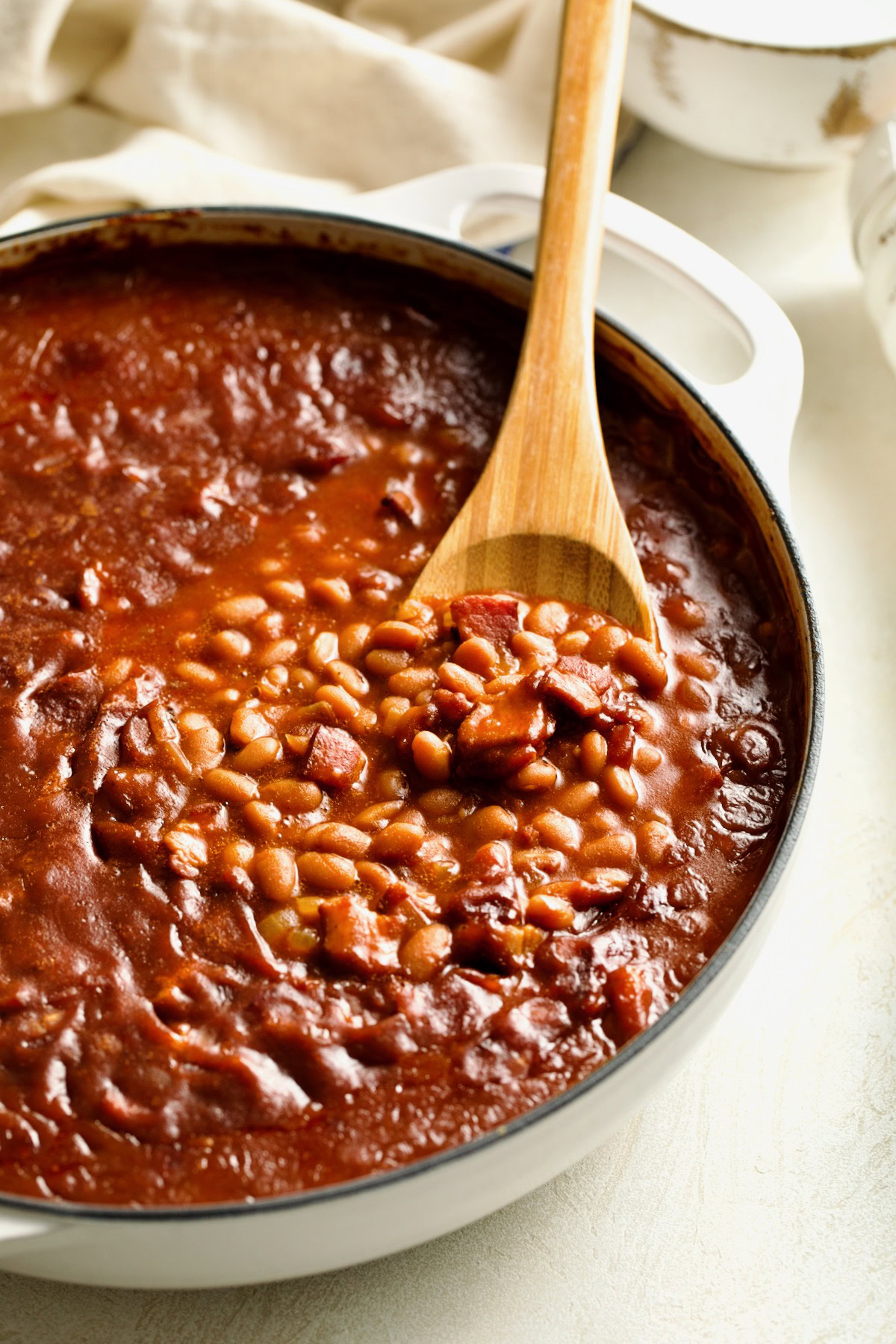 Close-up of smoky beans with bacon and sauce.