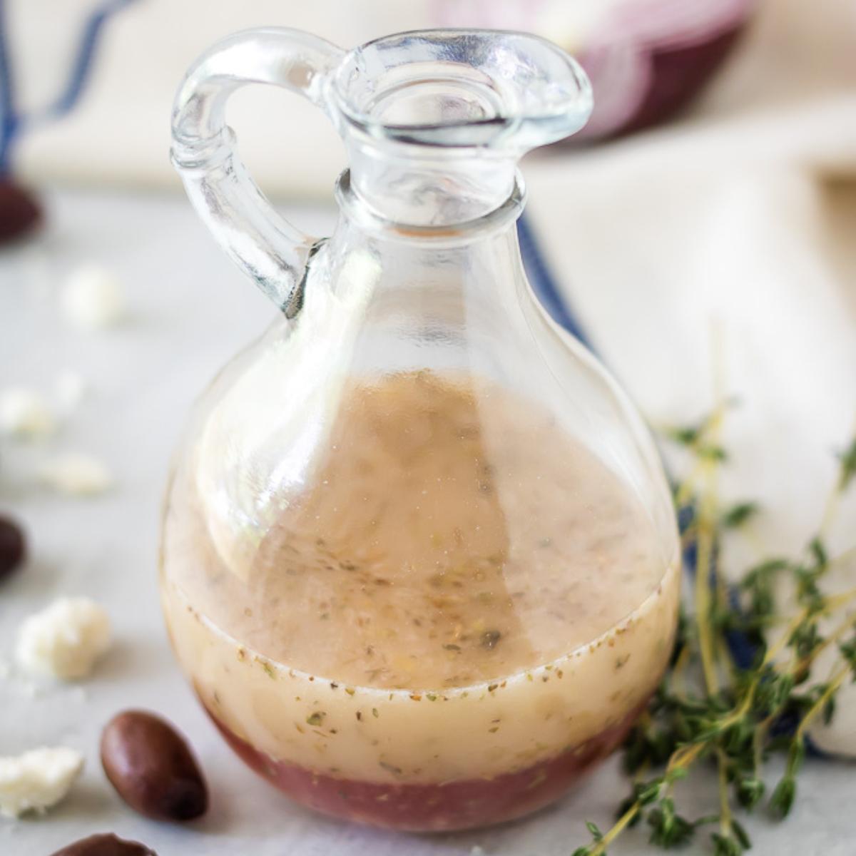 Greek salad dressing in a glass curet.