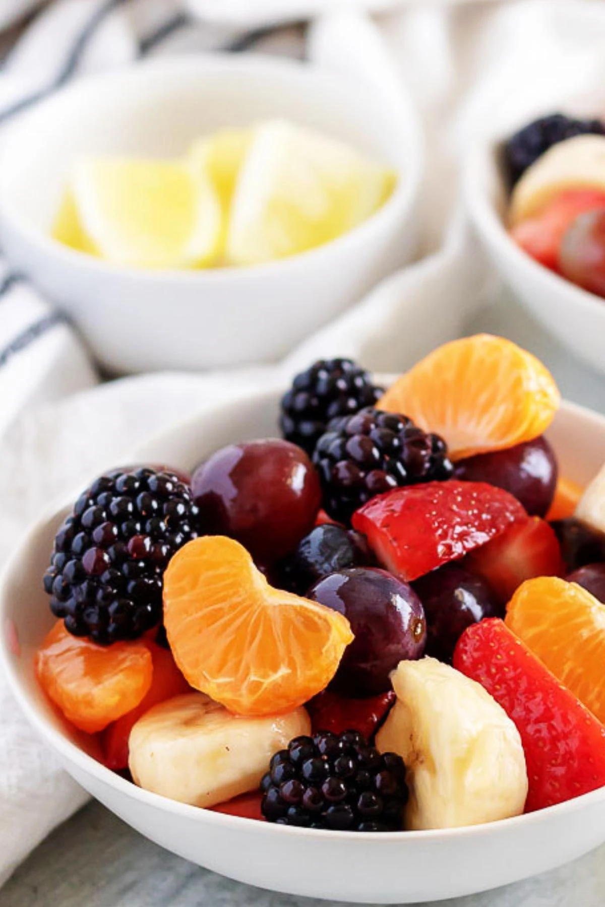 White dish filled with fresh fruit salad.