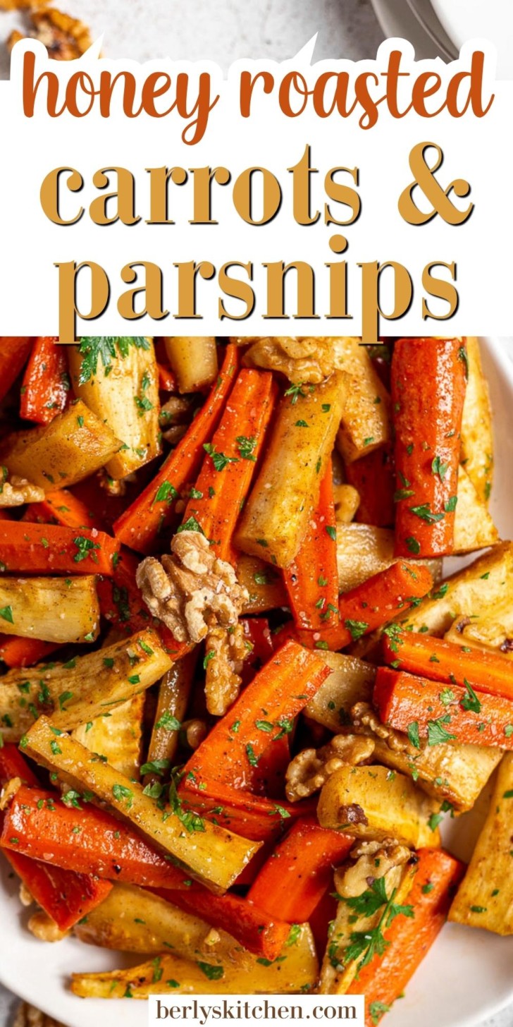 Close up view of honey roasted carrots and parsnips on a white platter.