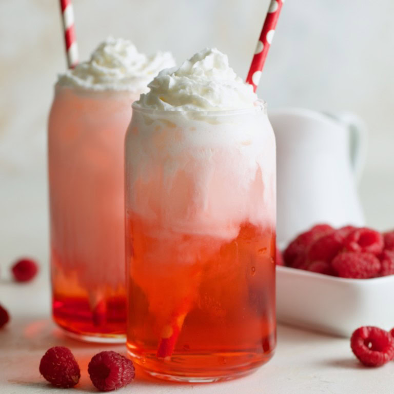 Raspberry Italian cream soda with whipped cream and fresh raspberries.
