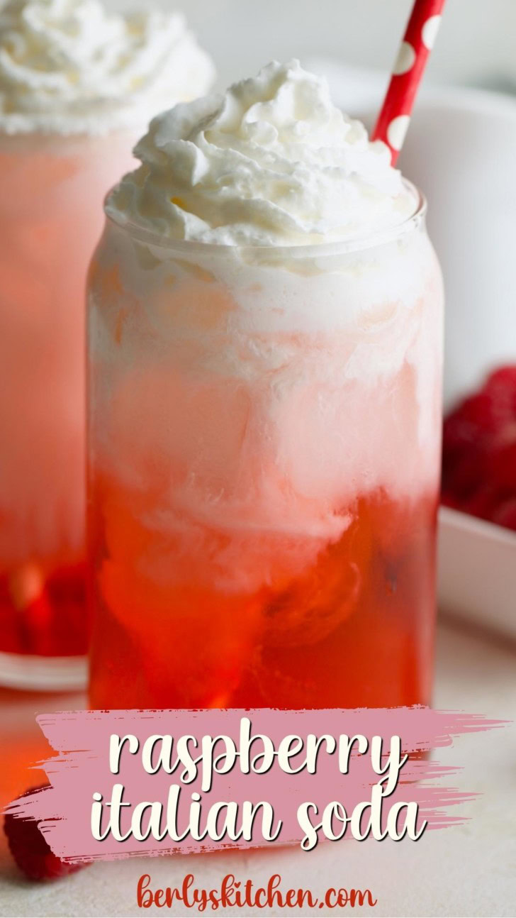 Close up view of raspberry italian soda with a straw.