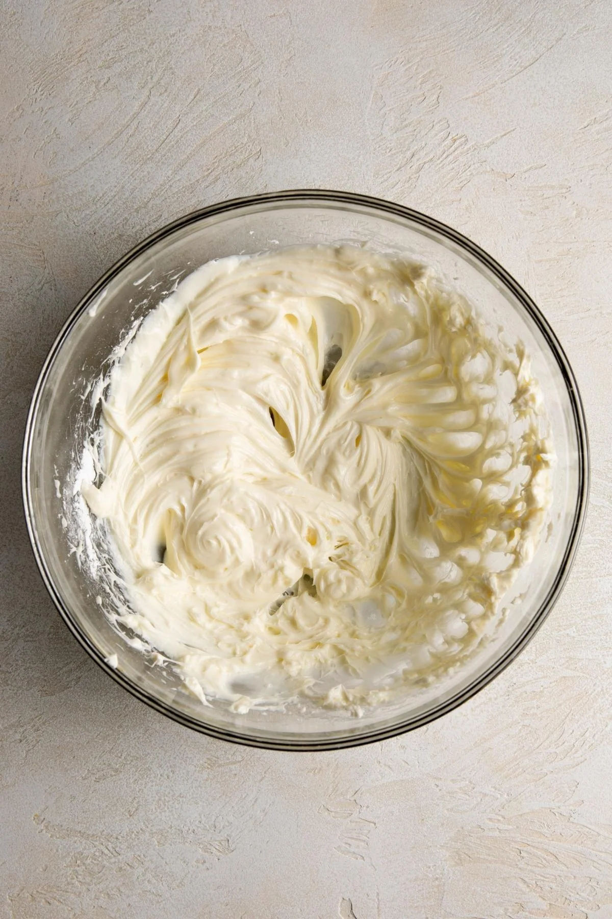 Whipped cream cheese mixture in a glass bowl.