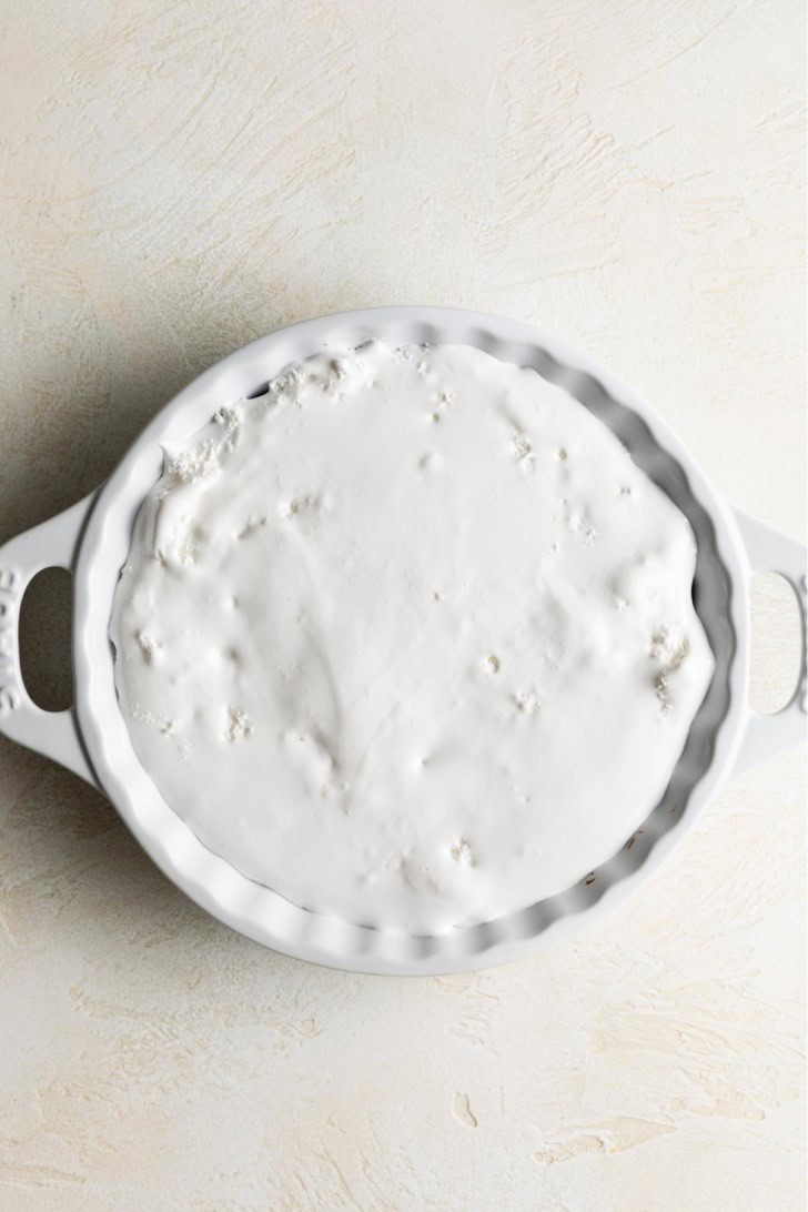 Marshmallow layer spread over chocolate s’mores dip.