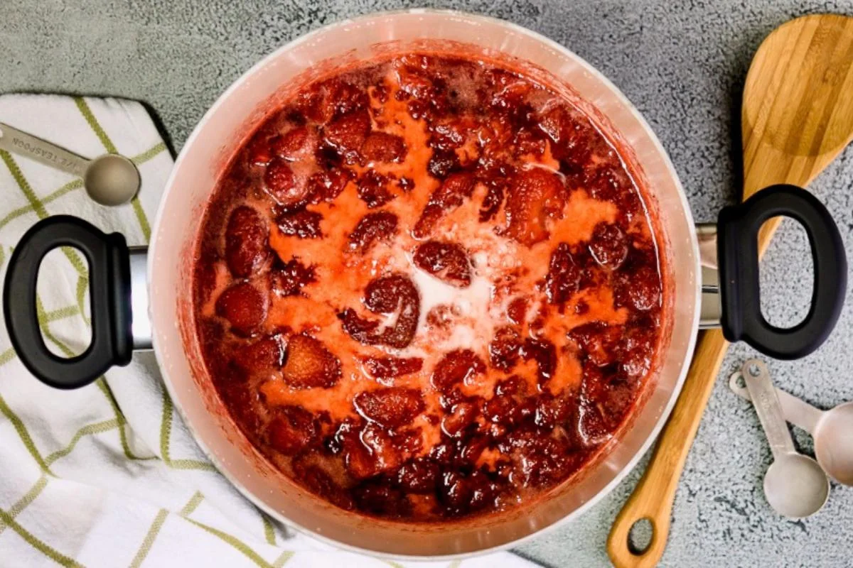 Strawberry jam cooking in a saucepan.