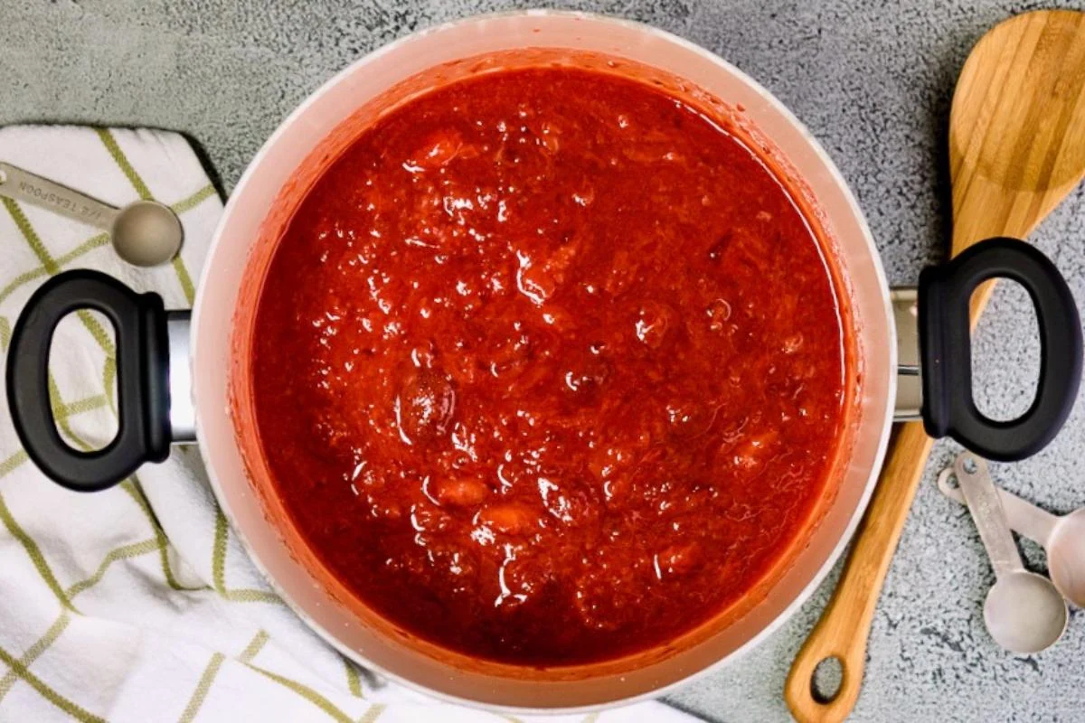 Thick strawberry jam in a saucepan.