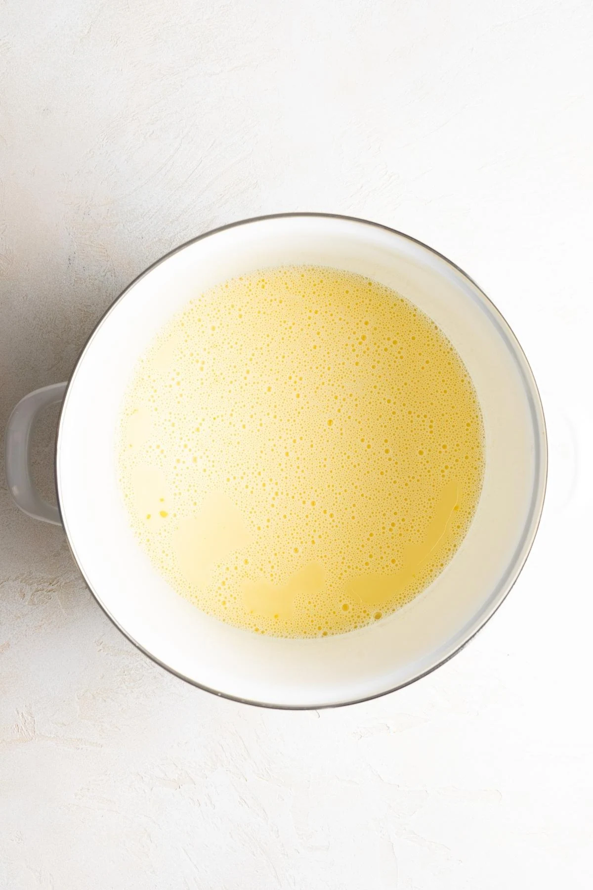 Egg yolks whisked into the warm cream mixture.