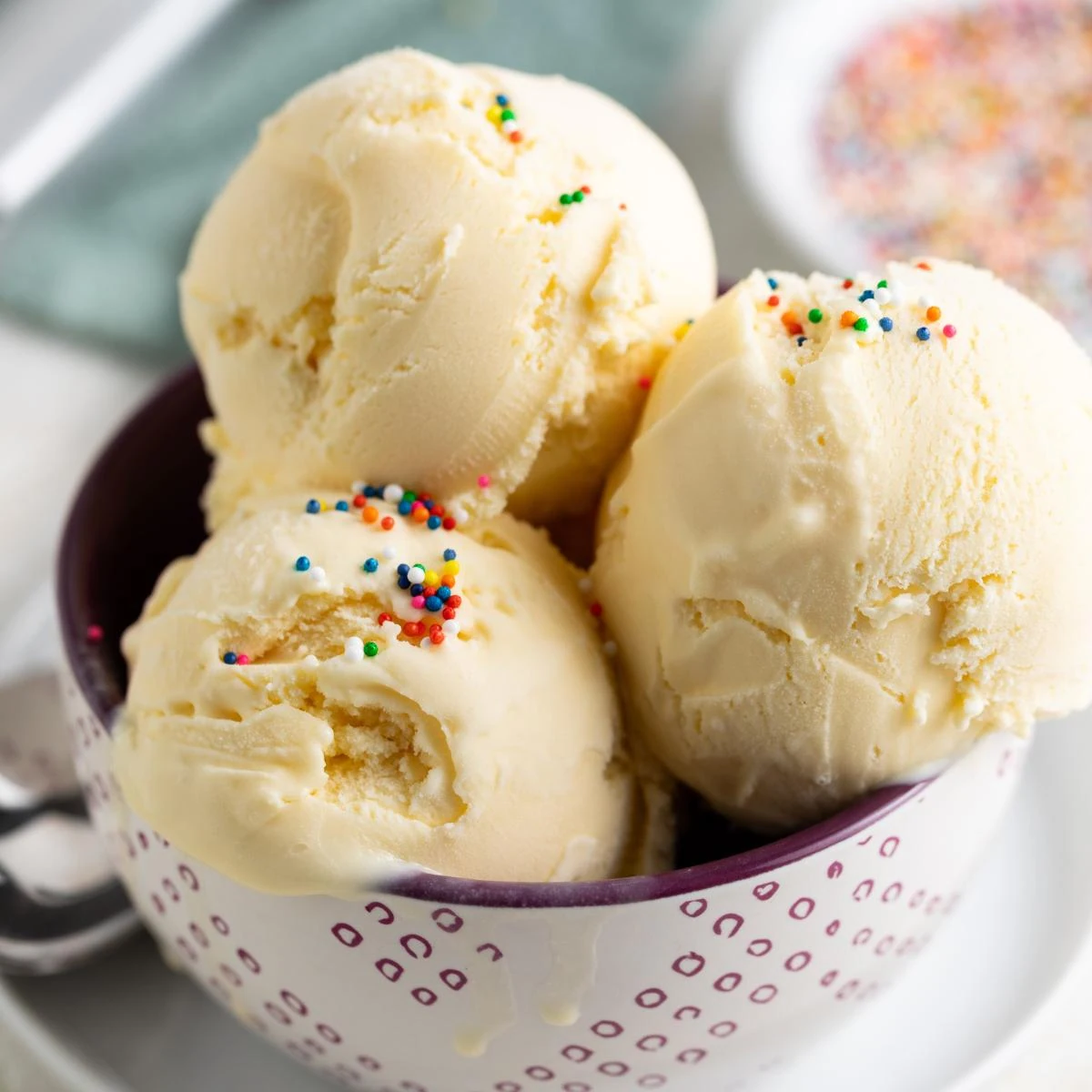 Close-up of creamy homemade vanilla ice cream with rainbow sprinkles.