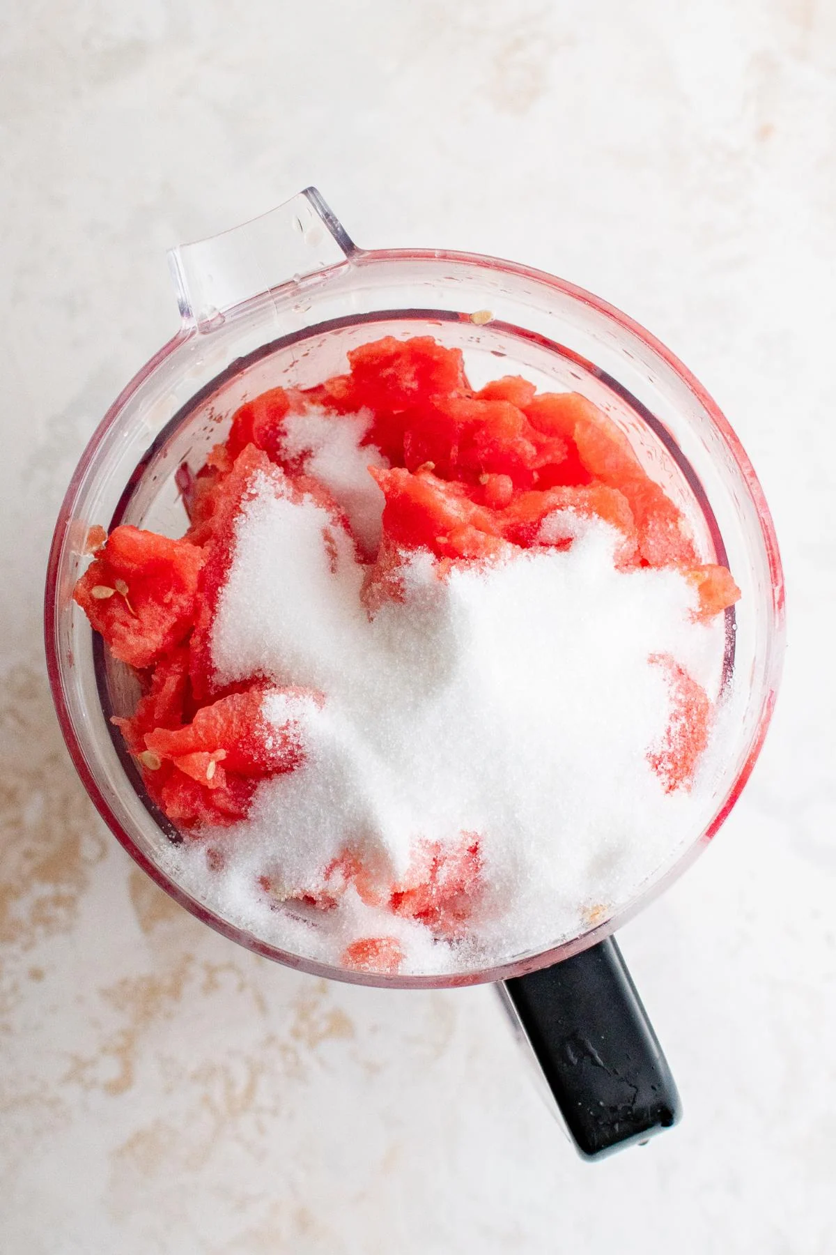 Watermelon, sugar, lime juice, and water in a blender.