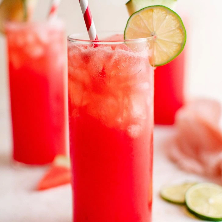 Close up view of watermelon agua fresca in three tall glasses.