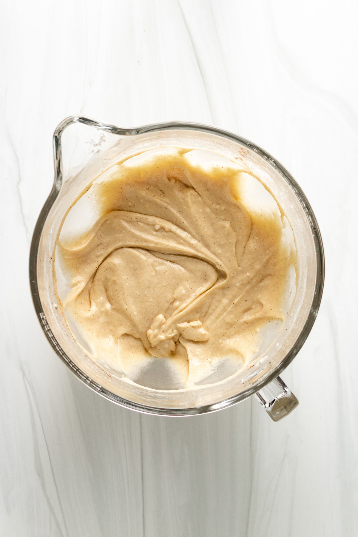 Gluten free apple cinnamon muffins in a glass mixing bowl.