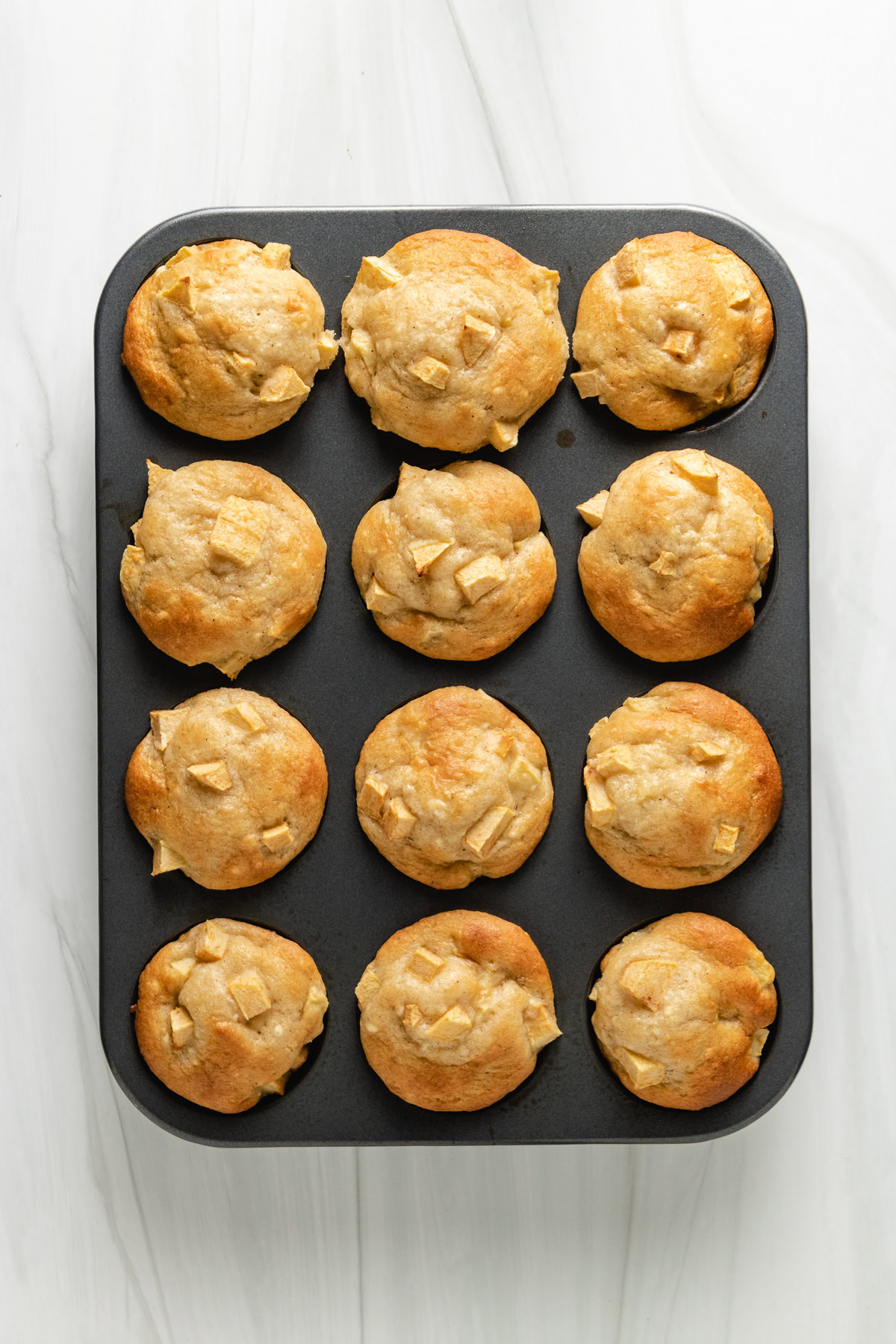 Gluten free apple cinnamon muffins in a muffin pan.
