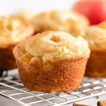 Close up view of gluten-free apple cinnamon muffins on a wire rack.