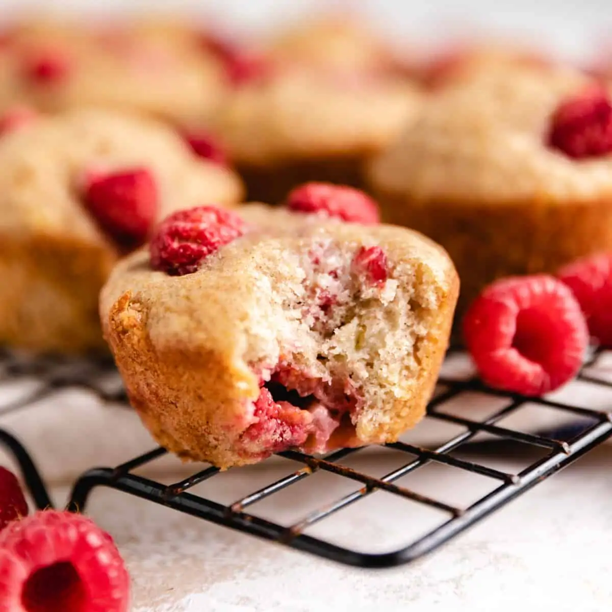 Bite taken out of a banana raspberry muffin.