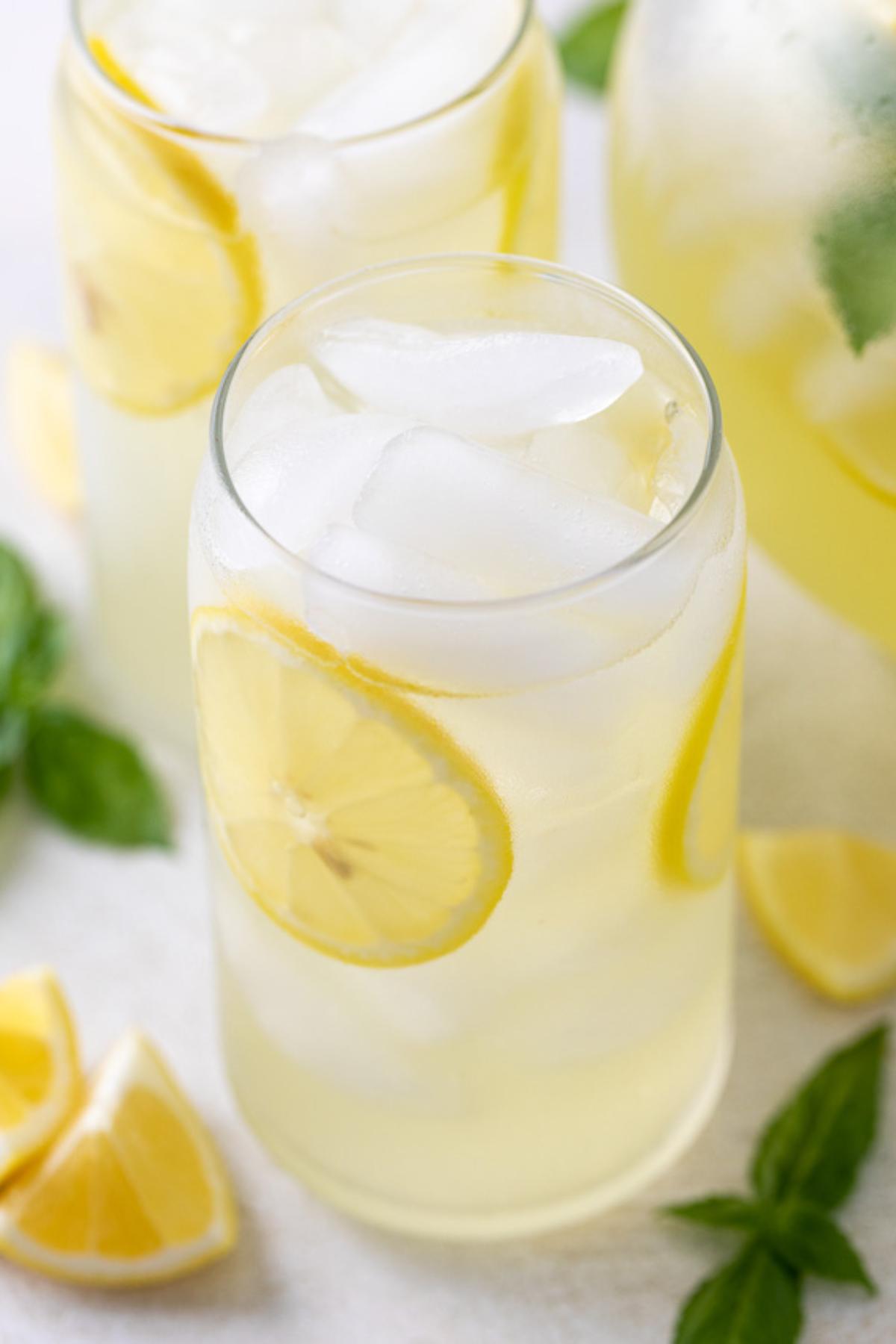 Lemon wheels in a glass of basil lemonade.