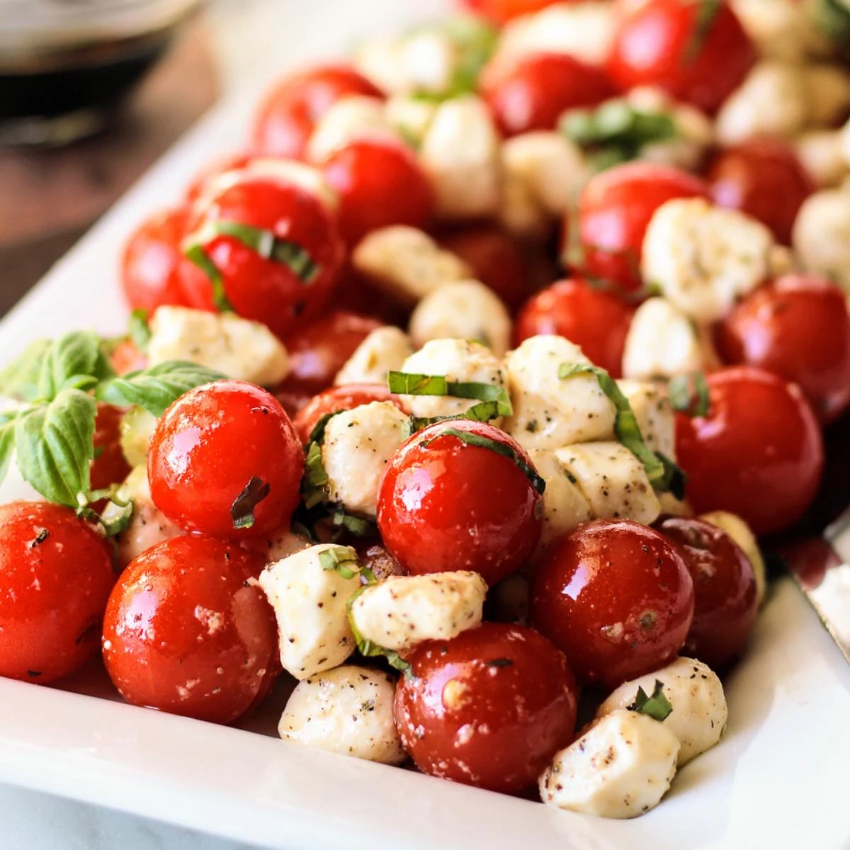 Close up view of caprese salad on a serving platter.