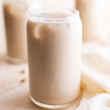 Creamy chai latte in a clear glass with a smooth texture and light color.