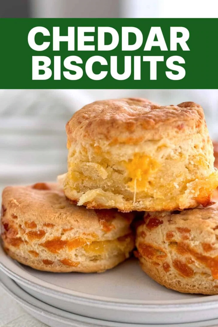 Cheesy biscuits stacked on gray plates.