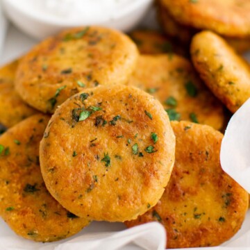 Close up view of chickpea fritters on parchment.
