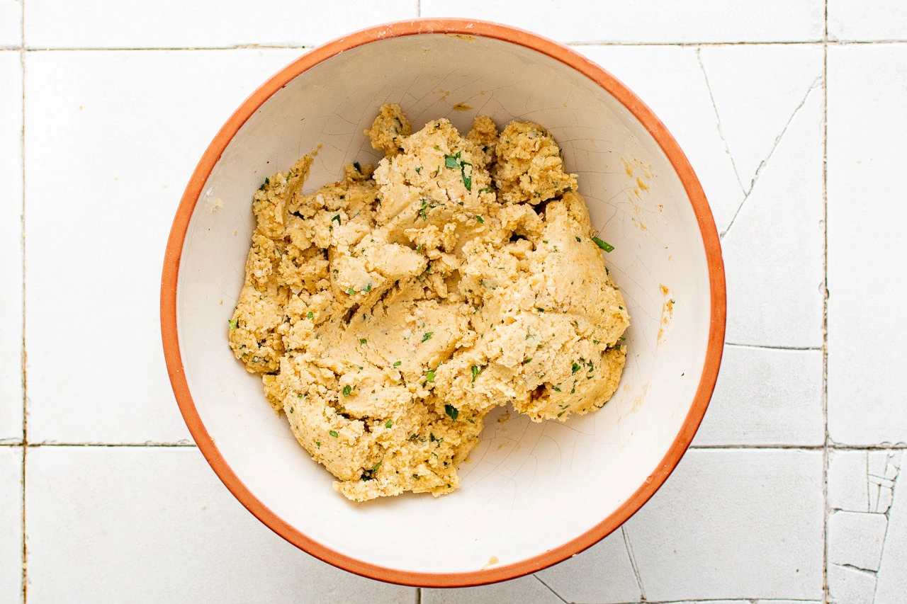 Chickpea fritter dough in a mixing bowl.