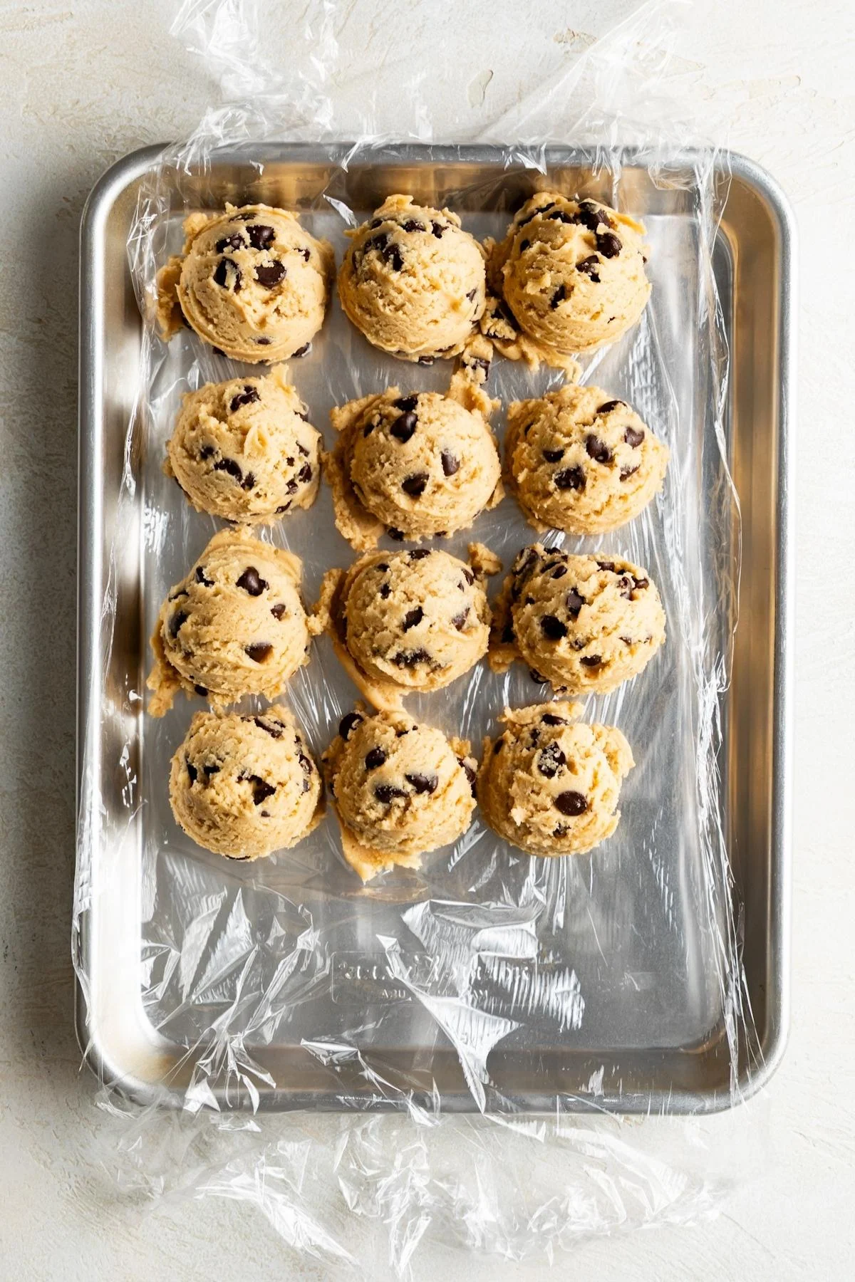Cookie dough portioned onto a baking sheet.
