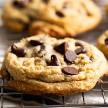 Close up view of chocolate chip cookies on a wire rack.