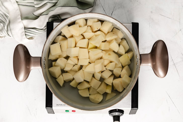 Cubed potatoes in a pot of water.