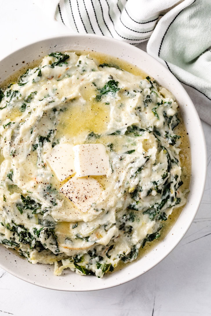 Overhead view of colcannon with melted butter.