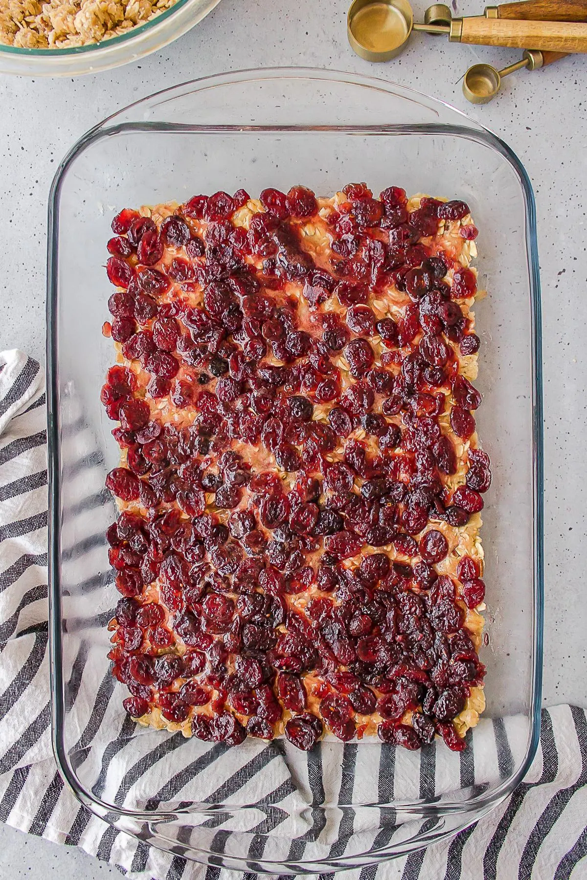 Cranberry filling spread over oat crumble base.
