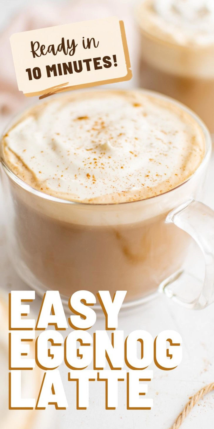 Eggnog latte in a mug topped with whipped cream and nutmeg.