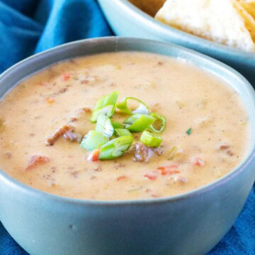 Close up view of hamburger dip in a green bowl.