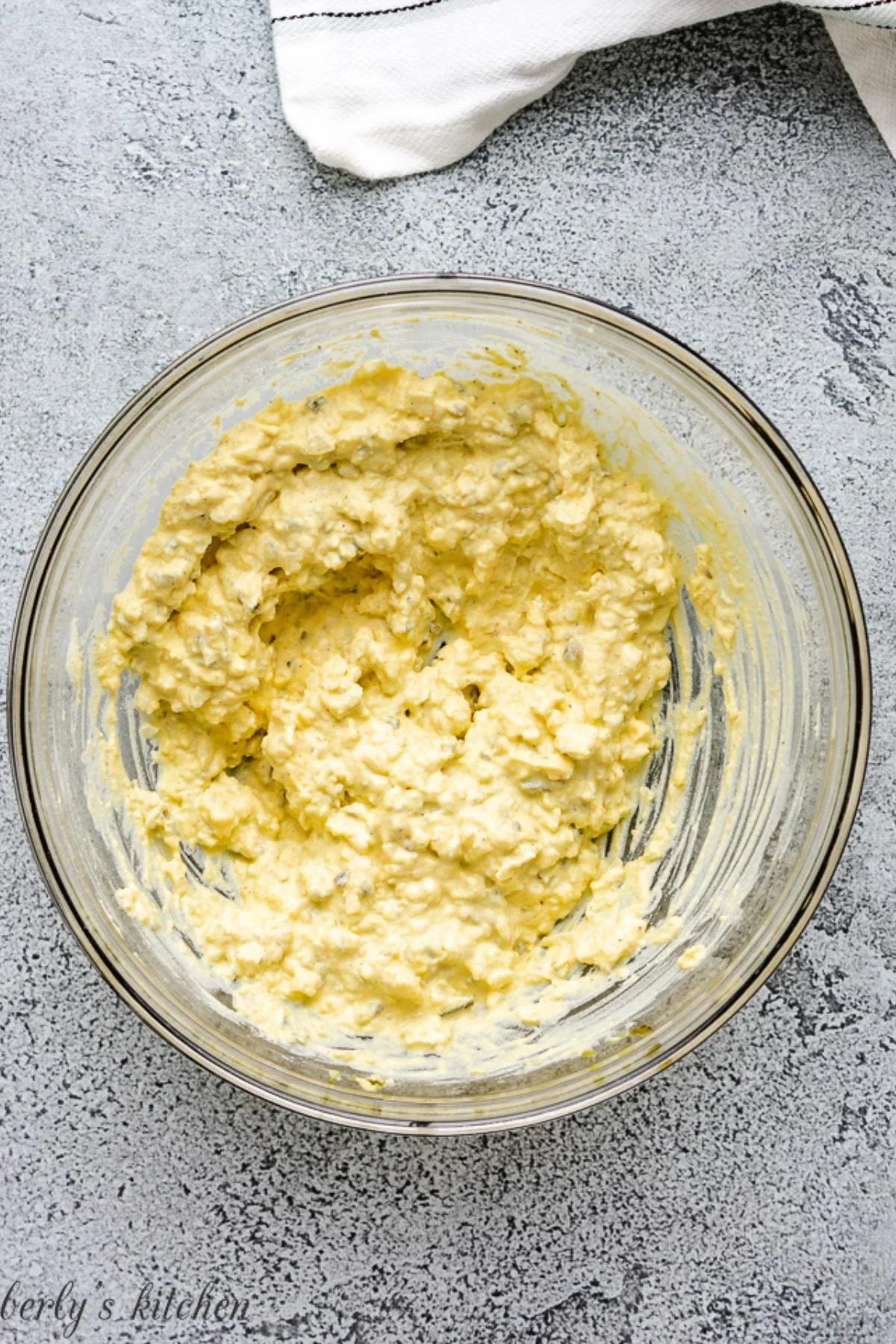 Bowl of deviled eggs filling in a glass bowl.