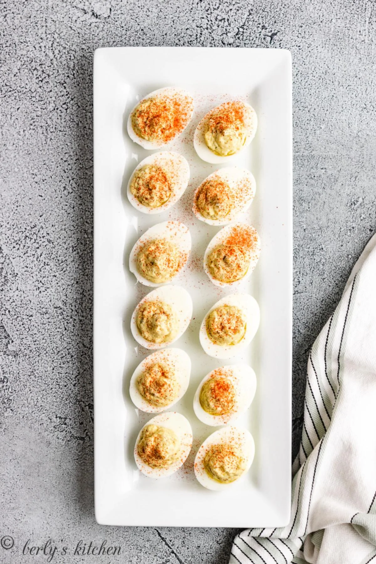 Deviled eggs on a white platter.