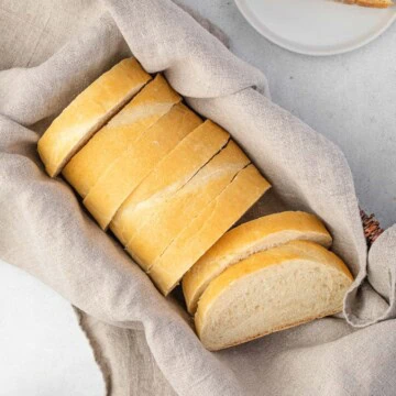 Overhead view of a loaf of sliced Italian bread.