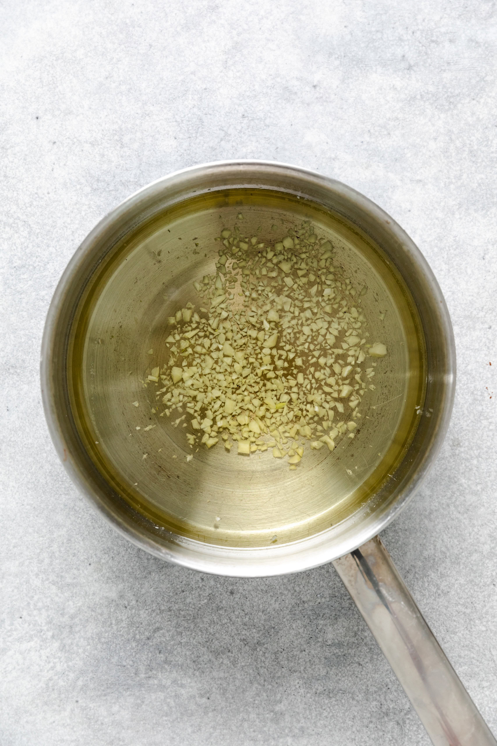 Minced garlic heating in olive oil.