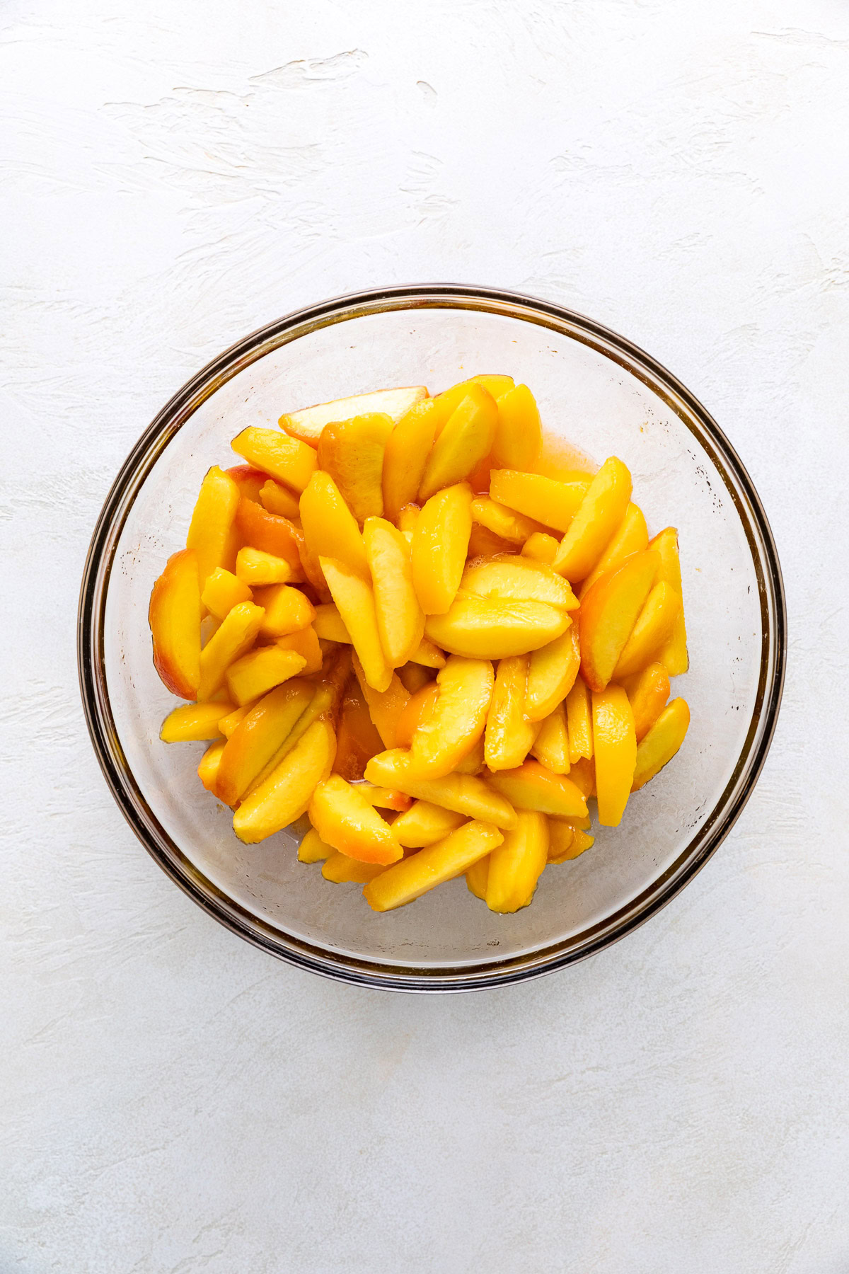 Macerated peach slices with released juices.