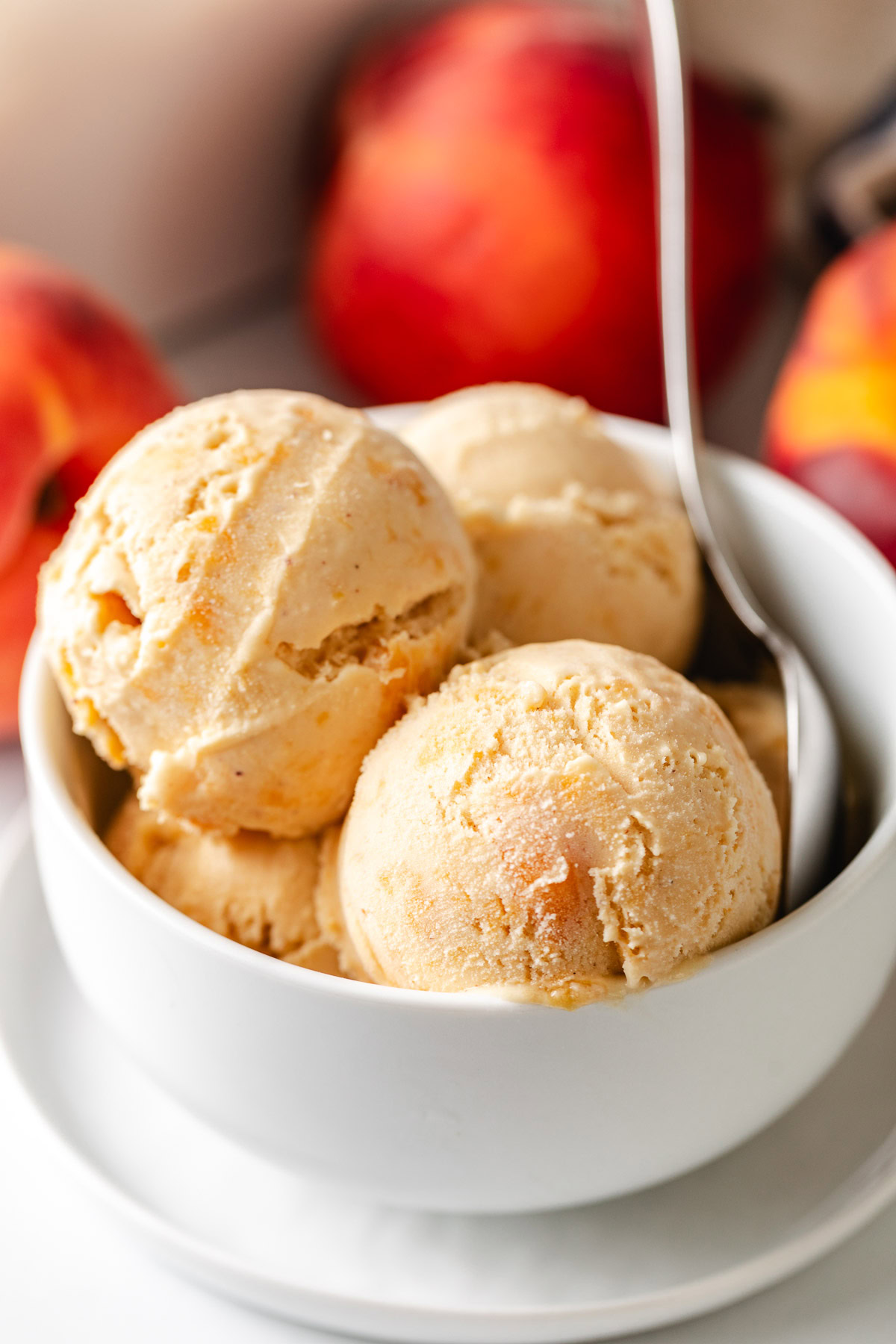 Scoops of brown sugar peach ice cream in a white dish.