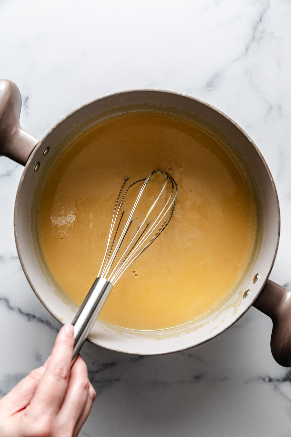 Ice cream custard base cooking in a pan.