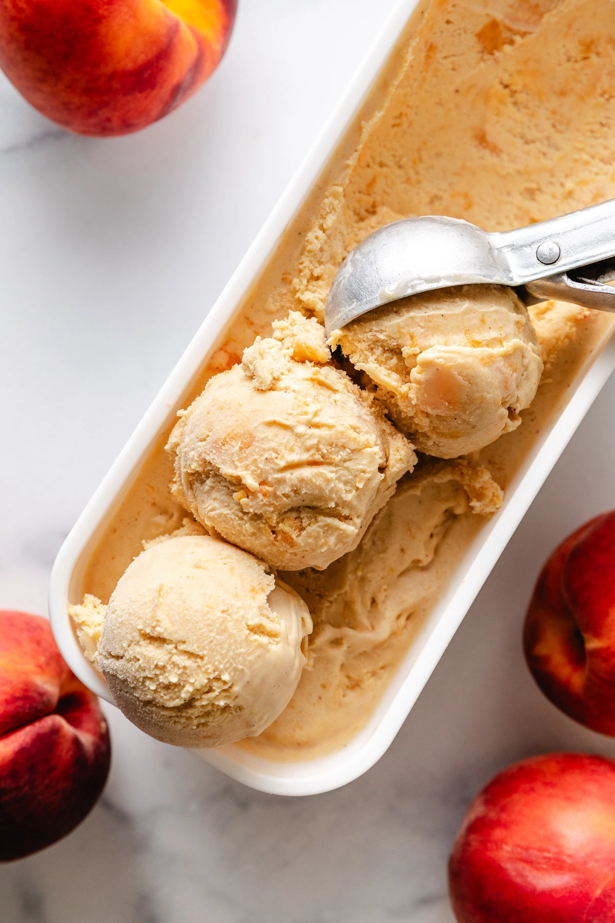 Overhead view of brown sugar peach ice cream in a container.