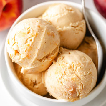 Overhead view of brown sugar peach ice cream in a white dish.