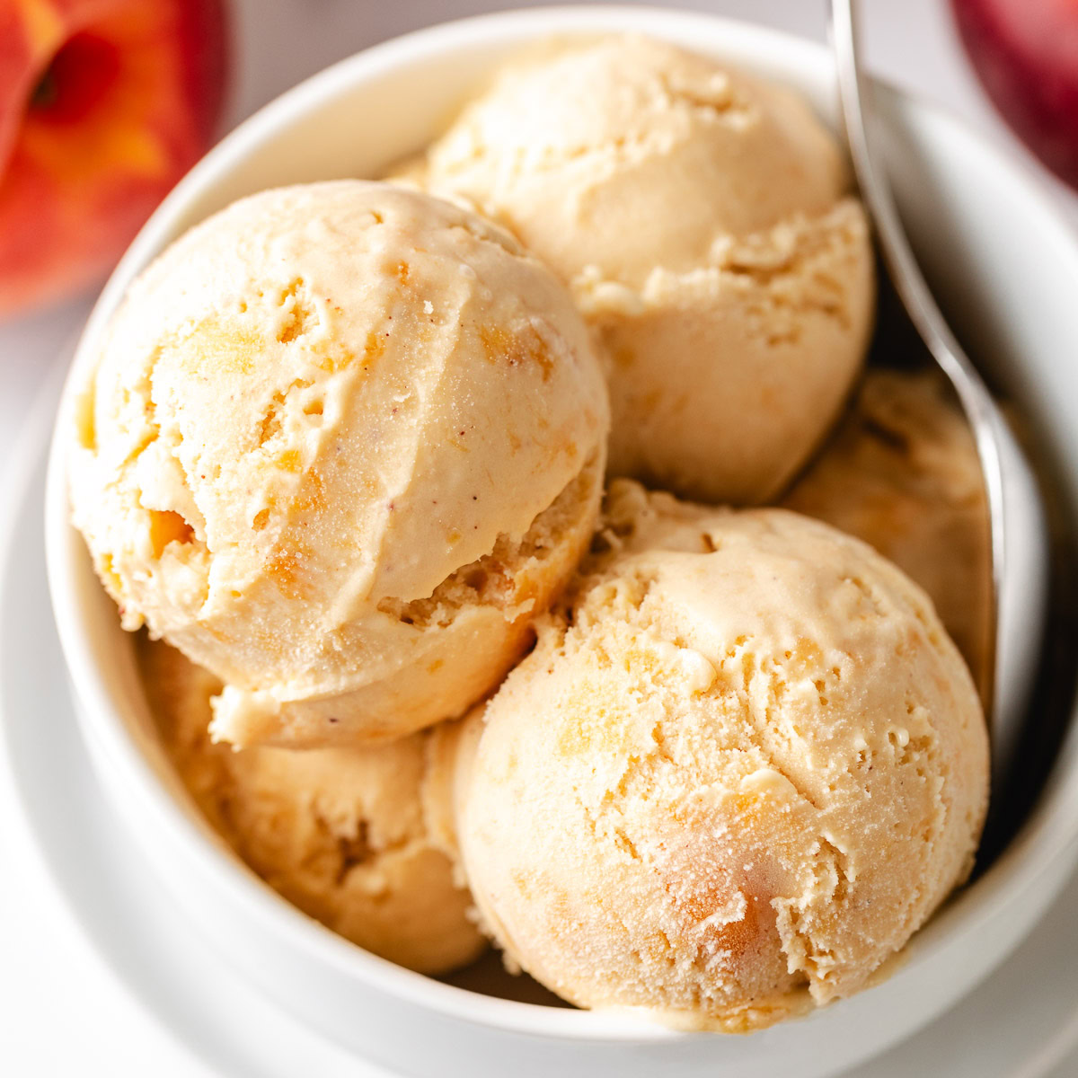 Overhead view of brown sugar peach ice cream in a white dish.