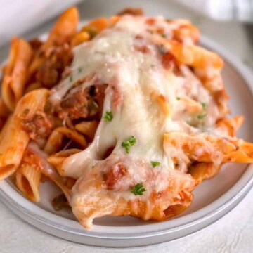Close up view of a plate of pizza pasta.